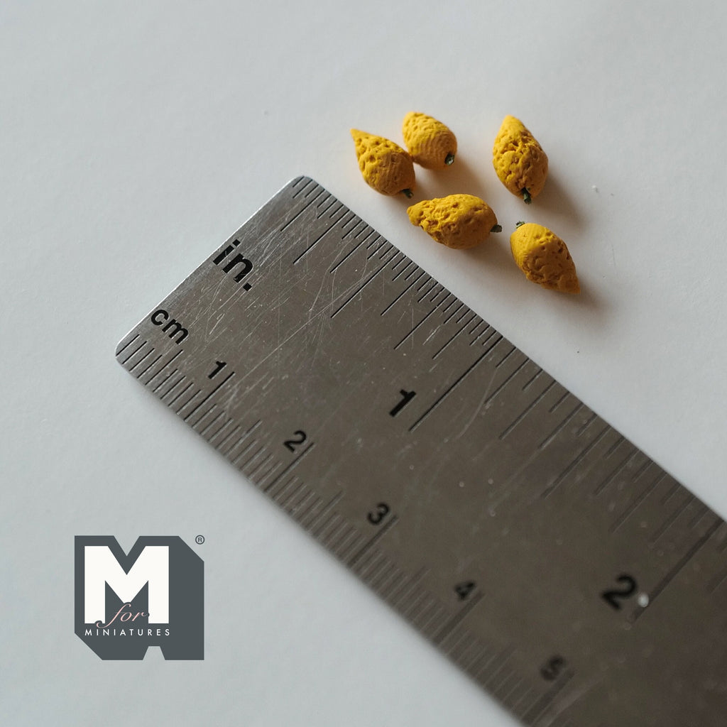 1:12 scale miniature rotten mangoes with yellow skin and dark spots, set of 5, shown with a ruler for scale