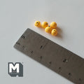 1:12 scale miniature unripe oranges in yellow, set of 5, shown with a ruler for scale