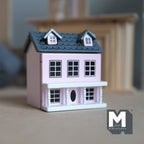 1:12 scale miniature little house in light pink with hinged front and roof, 2 rooms, gray roof with dormer windows