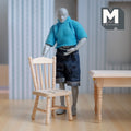 1:12 scale miniature unpainted wood spindle back side chair, shown beside a figure and a table for scale
