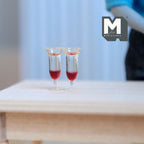 1:12 scale miniature stemmed wine glasses with red wine, set of 2, clear, shown on a light wood table