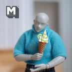 1:12 scale miniature soft serve ice cream cone in green and white swirl with kiwi slices, held by an artist figure