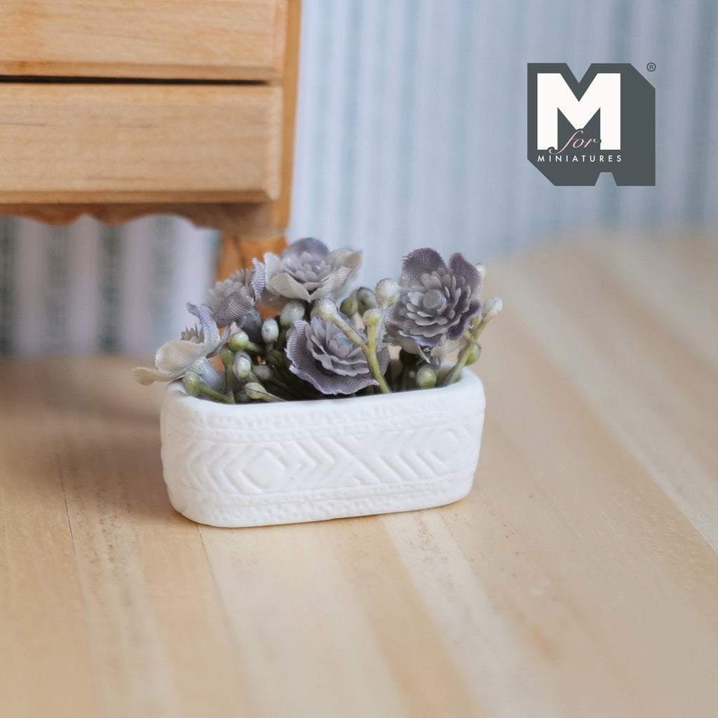 1:12 scale miniature succulents in a long white planter trough with gray leaves, shown on a wood floor