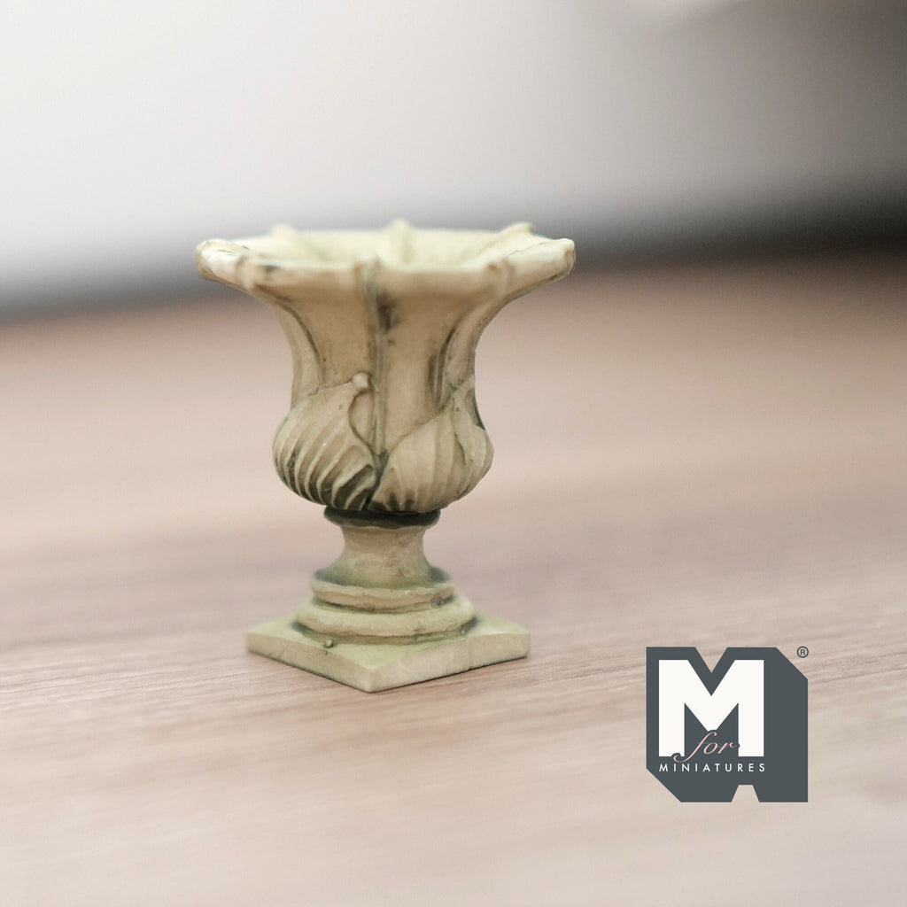 1:12 scale miniature cast resin Roman style garden urn with pedestal in antique cream, leaf relief, on a wood floor