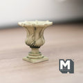 1:12 scale miniature cast resin Roman style garden urn with pedestal in antique cream, leaf relief, on a wood floor