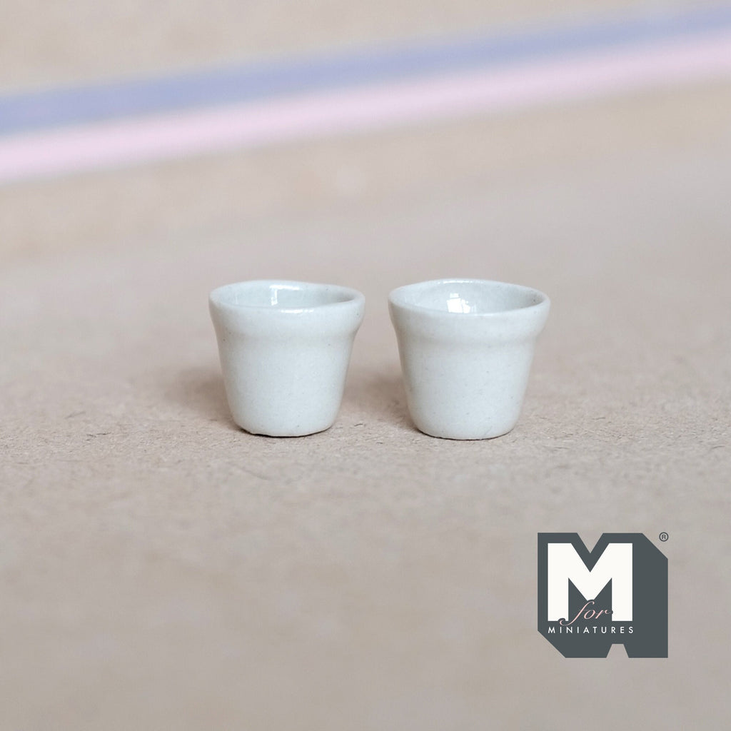 1:12 scale miniature white ceramic flower pots with tapered sides, set of 2, shown side by side on a beige surface