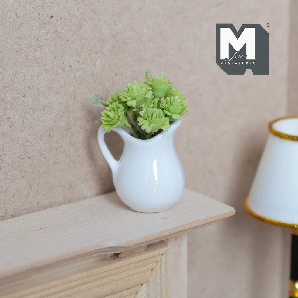 1:12 scale miniature green flowers in a white ceramic pitcher vase, shown on a wood mantel shelf