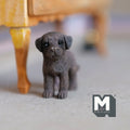 1:12 scale miniature brown cast resin standing Labrador puppy, chocolate color, shown on a floor near a table leg