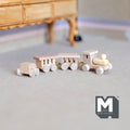 1:12 scale miniature unpainted wood train, 4 pieces, engine with three cars in natural wood, shown on a beige carpet