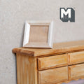 1:12 scale miniature photo frame kit with glazing and backing, unpainted wood rectangular frame shown on a wood dresser