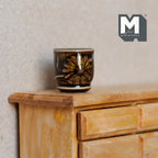 1:12 scale miniature ceramic planter pot in dark brown glaze with a patterned band, shown on a wood dresser