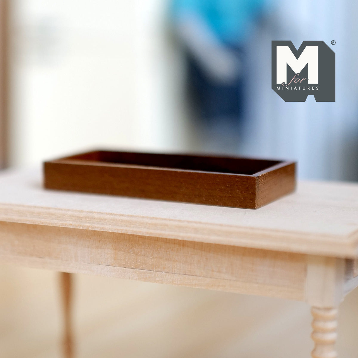 1:12 scale miniature wood rectangular serving tray in walnut finish with raised sides, shown on a light wood table