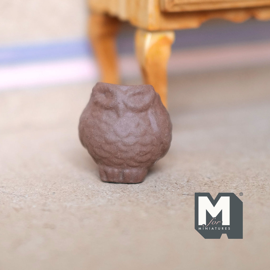 1:12 scale miniature brown clay owl shaped flower pot with feather texture, shown on a floor near a wood table