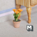 1:12 scale miniature potted chrysanthemum with orange blooms and green leaves in a terracotta pot, shown on the floor