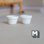 1:12 scale miniature terracotta clay flower pots in cream white, set of 2, shown empty side by side on a floor