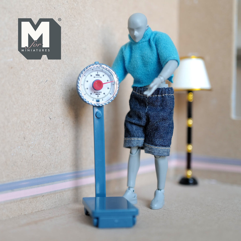 1:12 scale miniature blue standing weighing scale with round dial, non working, shown with a poseable figure