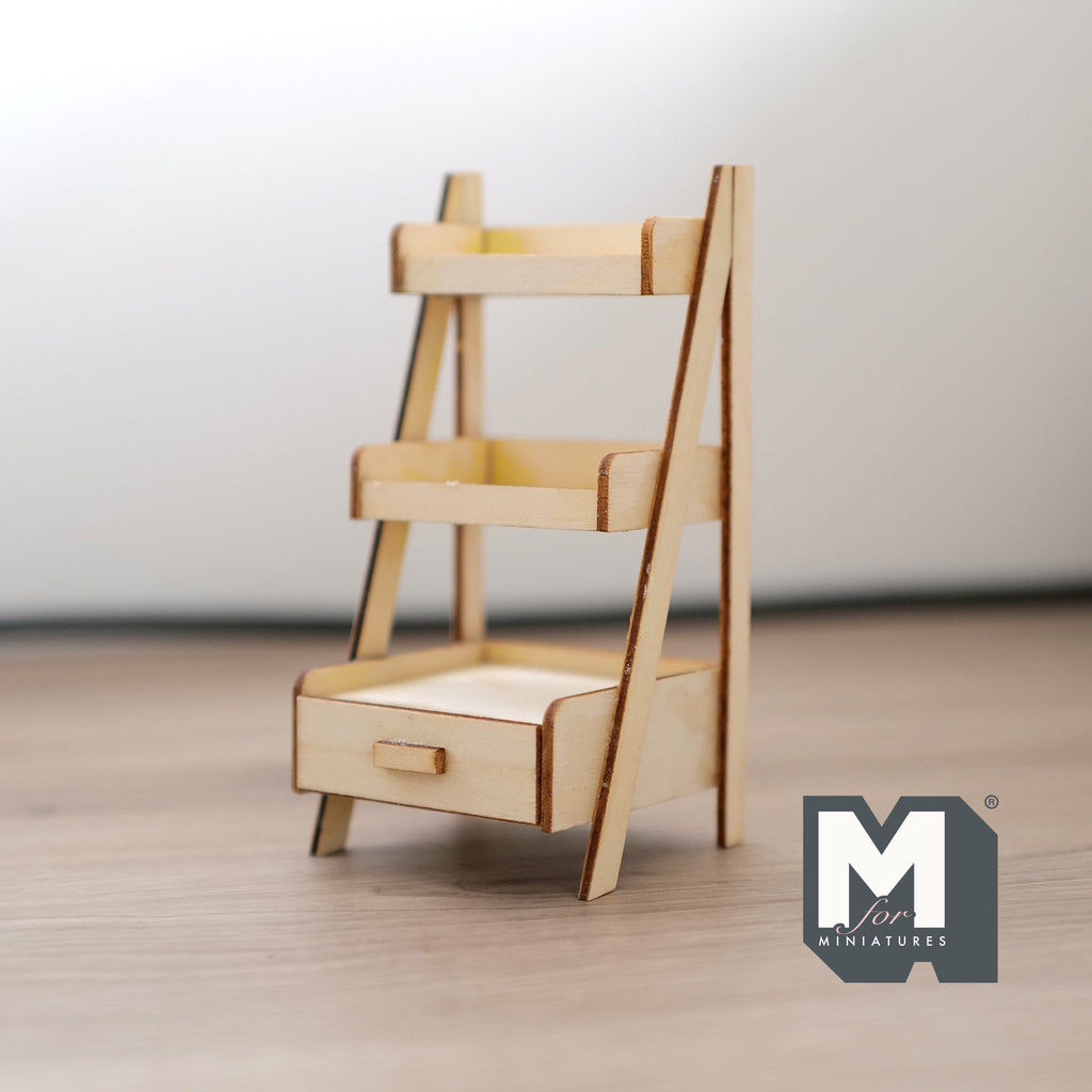 1:12 scale miniature unpainted wood planter shelf with 3 tiers and a bottom drawer, ladder style frame on a wood floor