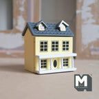 1:12 scale miniature wood little house in light yellow with hinged front and roof, 2 rooms, gray roof with dormers