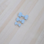 1:12 scale miniature metal hexagon dumbbells in light blue, set of 3, shown on a light wood surface