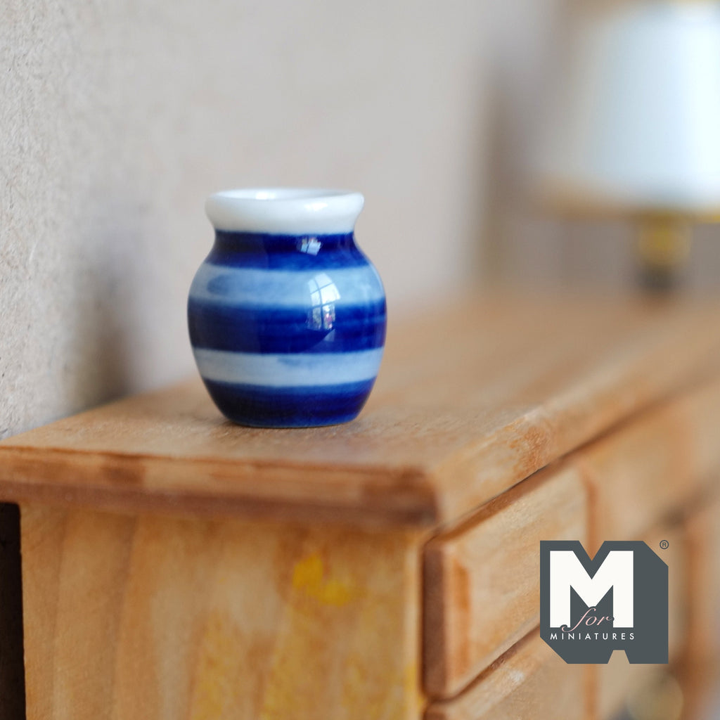 1:12 scale miniature two tone ceramic flower pot, blue and white striped, shown on a wood dresser