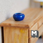 1:12 scale miniature cobalt blue glazed ceramic planter bowl, round squat shape, shown on a wood dresser