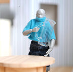 1:12 scale miniature glass water pitcher, large clear ribbed jug with handle, held by a poseable figure for scale