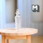 1:12 scale miniature glass pasta jar with stopper and spaghetti, diamond cut pattern, on a round wood table