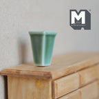 1:12 scale miniature ceramic square tapered vase in glossy jade green, shown on a wood dresser