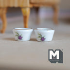 1:12 scale miniature ceramic flower pots in white with a purple floral print, set of 2, shown on a gray floor