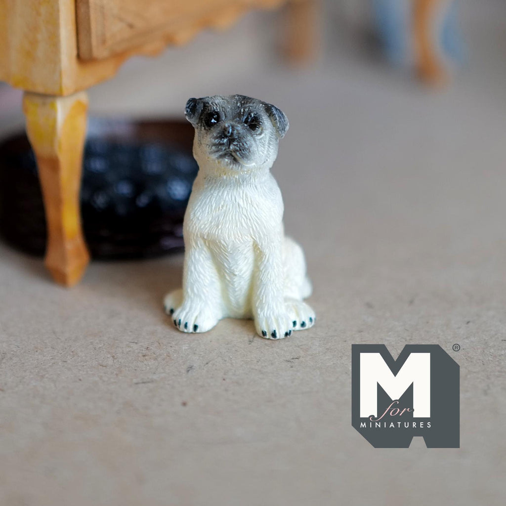 1:12 scale miniature sitting pug dog figurine in beige cast resin with dark face, shown on a carpet floor