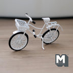 1:12 scale miniature kid's bike with front basket in white with black tires, shown on a wood floor
