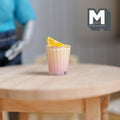1:12 scale miniature orange slush in a glass with lemon slice on the rim, large size, on a round wood table