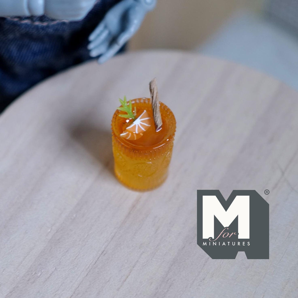 1:12 scale miniature fruit punch in a glass with ice, large, orange drink with garnish, non edible, on a wood table