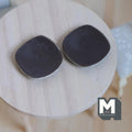 1:12 scale miniature dark brown ceramic dining plates with rounded square shape, set of 2, shown on a round wood table
