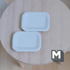 1:12 scale miniature ceramic rectangular dining plates in white with rounded corners, set of 2, on a round wood table