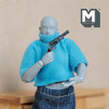 1:12 scale miniature vintage style revolver with dark grip, non working, shown held by a poseable figure