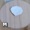 1:12 scale miniature large white serving plate with faceted irregular edge, shown on a round wood table