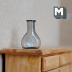 1:12 scale miniature gray glass bottle vase with round body and narrow neck, shown on a wood dresser