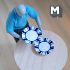 1:12 scale miniature ceramic dinner plates in white with a blue striped rim, large, set of 2, on a round wood table