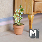 1:12 scale miniature potted ivy plant on stake with variegated green and white leaves in terracotta pot, on a floor