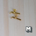 1:12 scale miniature metal faucet in gold, set of 2 with curved spouts, shown on a light wood surface