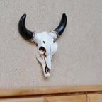 1:12 scale miniature bull skull wall decor in cast resin, white skull with long black horns, hanging on a wall
