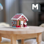 1:12 scale miniature gingerbread house with Santa, candy cane and Christmas tree, red and white icing, on a wood table
