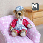 1:12 scale miniature plush mama bear in striped cap and overalls with red polka dot shirt, sitting on a pink armchair