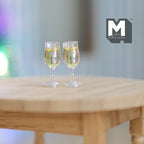 1:12 scale miniature white wine glasses with pale yellow wine, set of 2, shown on a round wood table