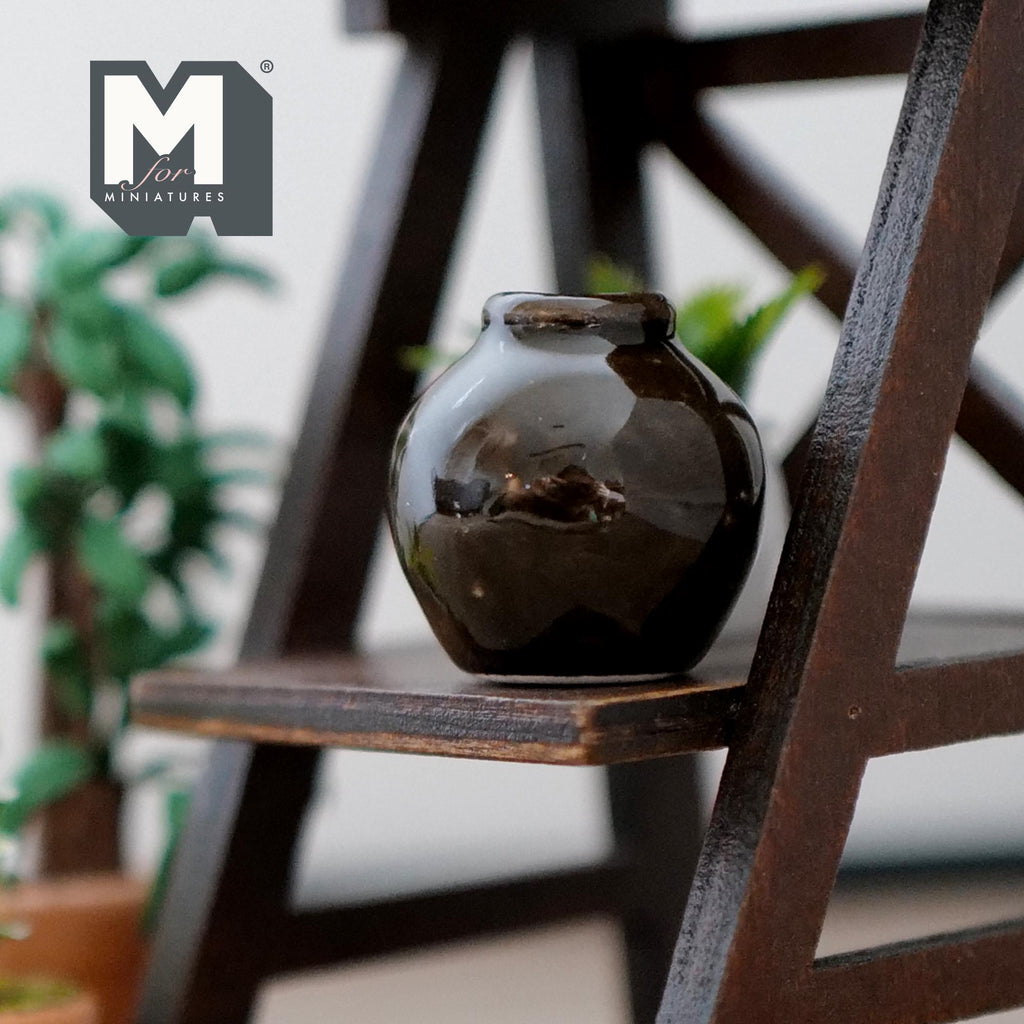 1:12 scale miniature ceramic round flower pot with a dark brown glaze, shown on a dark wood plant stand