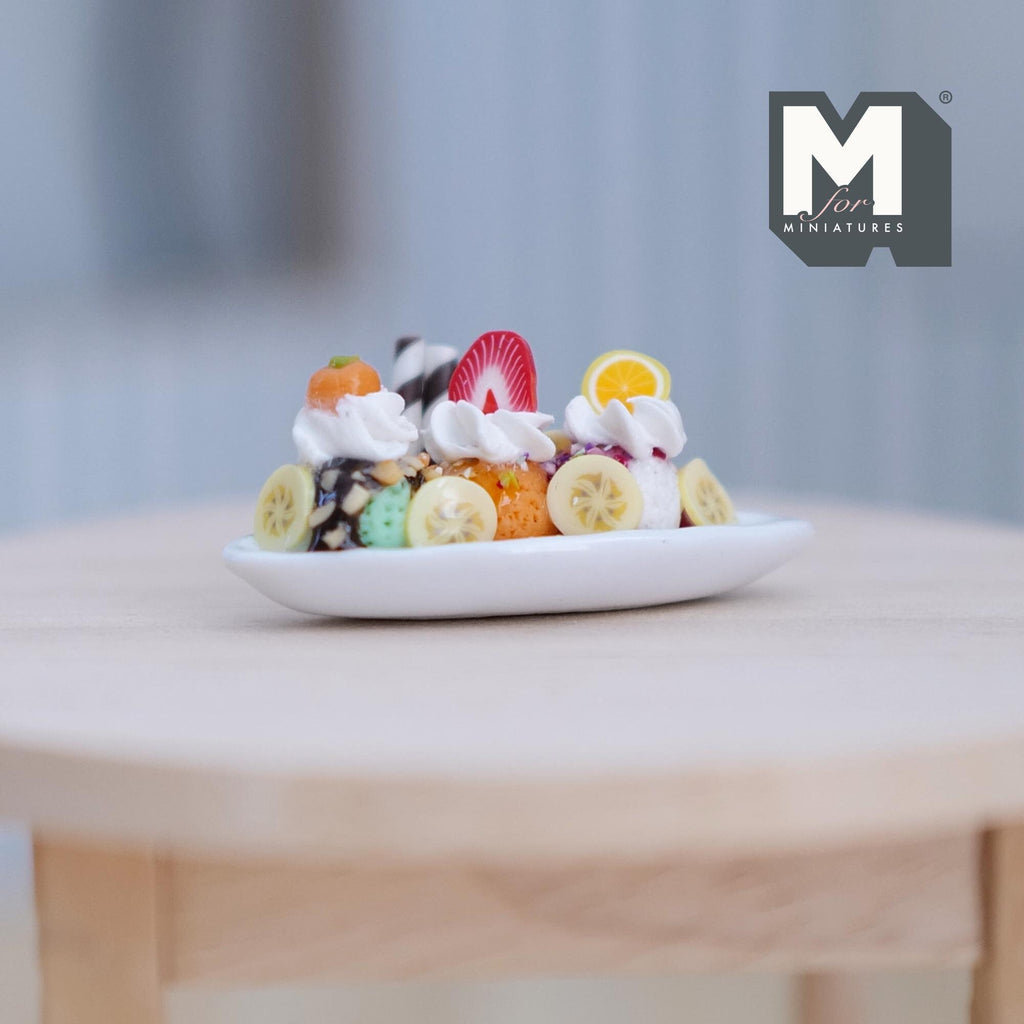 1:12 scale miniature strawberry banana split sundae in a white oval dish with whipped cream and fruit slices