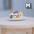1:12 scale miniature strawberry banana split sundae in a white oval dish with whipped cream and fruit slices