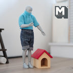 1:12 scale miniature wood dog house with red roof and arched door, shown beside a poseable figure for scale