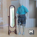 1:12 scale miniature full length oval cheval mirror on a brown metal tilting stand, shown beside an artist figure